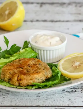 clam cakes with lemon and tartar sauce on a plate