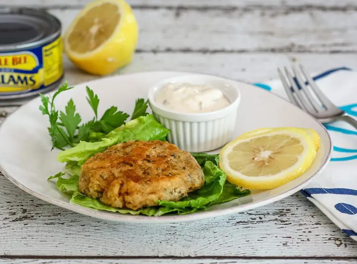 clam cakes with lemon and tartar sauce on a plate