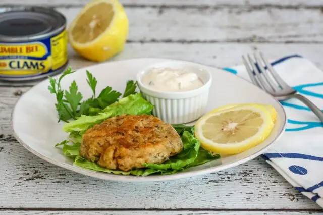 clam cakes with lemon and tartar sauce on a plate