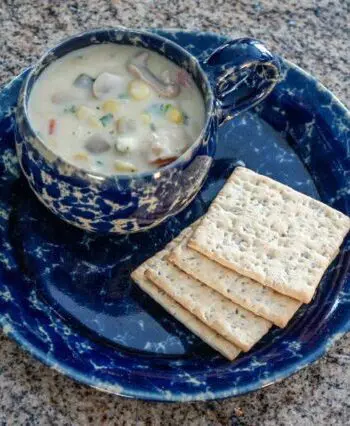 clam and corn chowder with crackers on the side