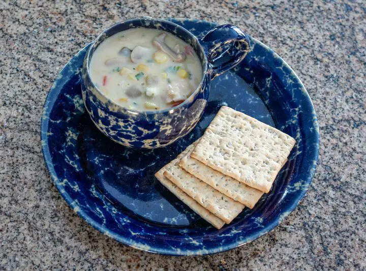 clam and corn chowder with crackers on the side