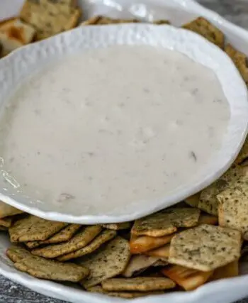 clam dip in a serving bowl with crackers