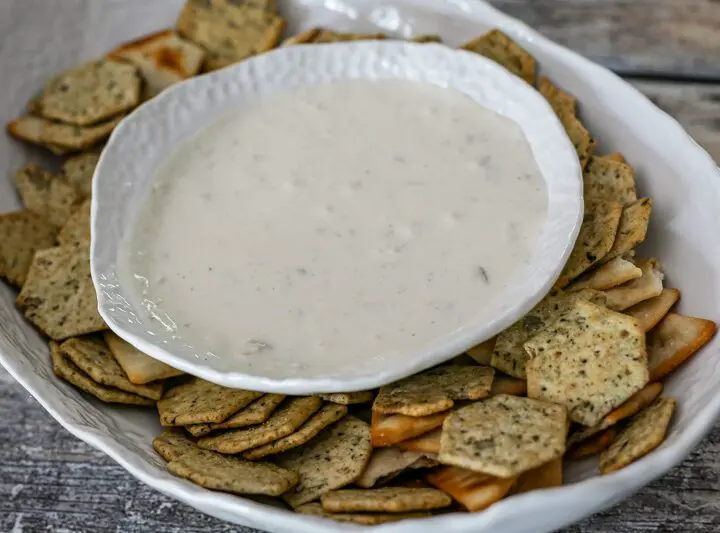 clam dip in a serving bowl with crackers