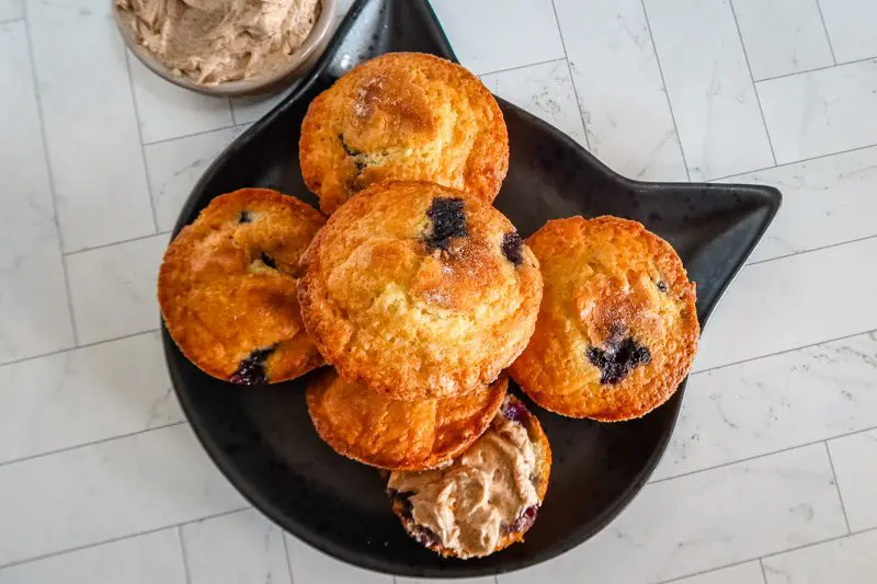 blueberry muffins on a plate with cinnamon butter