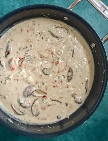 saucepan with chicken and mushrooms