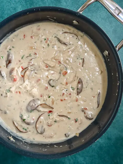 saucepan with chicken and mushrooms