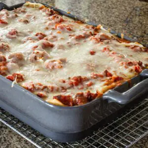 A baking dish of lasagna on a cooling rack