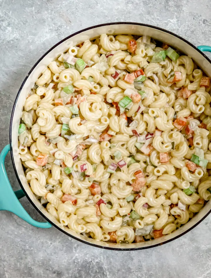 A creamy, flavorful macaroni salad in a Dansk pot for serving.