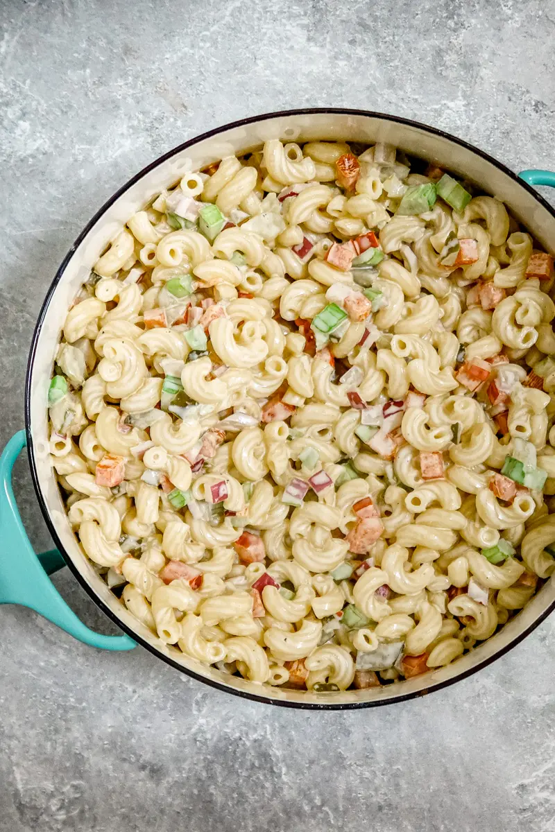 A creamy, flavorful macaroni salad in a Dansk pot for serving.