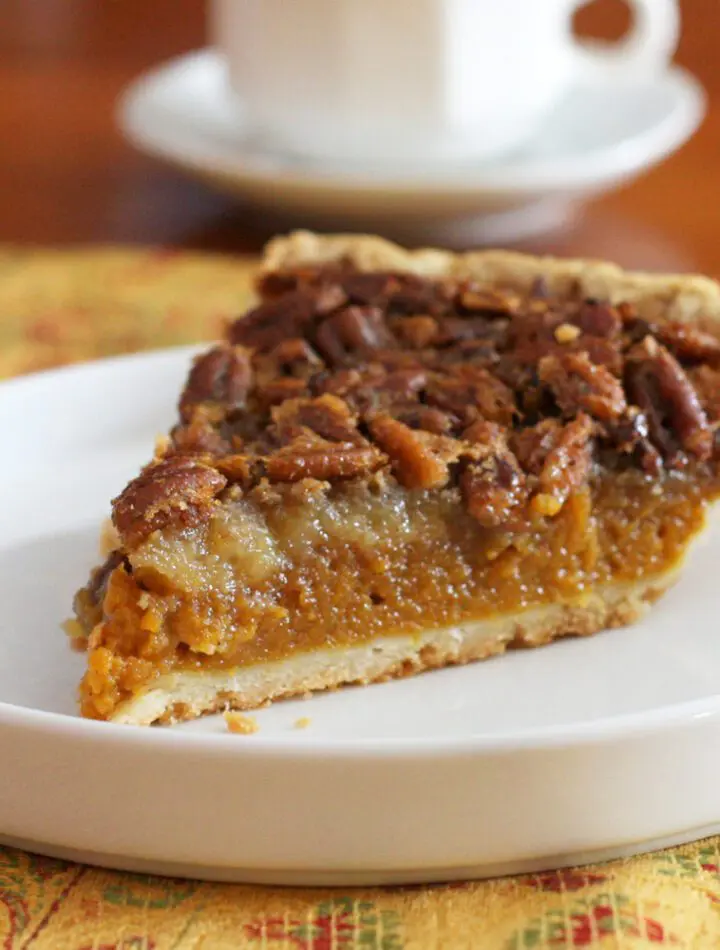 A classic pumpkin pecan pie on a dessert plate