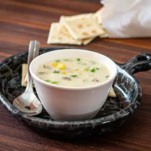 corn chowder with bacon on a lunch plate with crackers