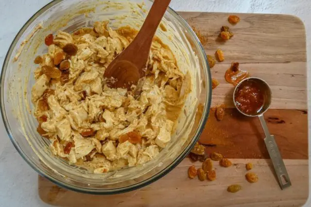 preparing coronation chicken with raisins