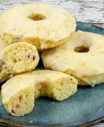 baked cranberry orange donuts on a plate