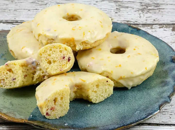 baked cranberry orange donuts on a plate