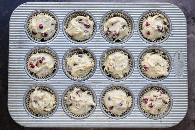 Cranberry muffin preparation;filling the muffin tin.