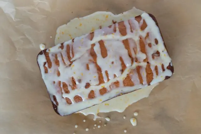 applying the glaze to a loaf of cranberry sauce bread