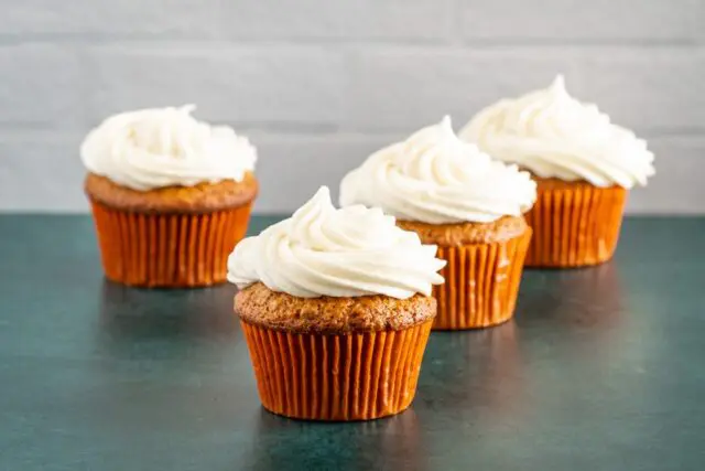 cupcakes decorated with cream cheese frosting