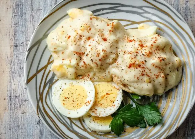 creamed eggs on biscuits with sliced eggs on the side