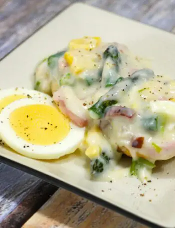 creamed ham and asparagus with hard boiled eggs on a plate