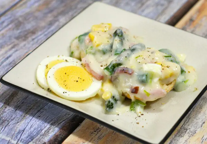 creamed ham and asparagus with hard boiled eggs on a plate