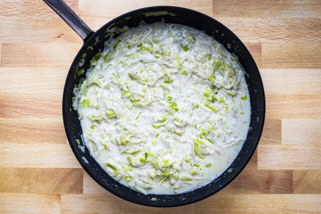 Add the cream and Parmesan cheese to the leeks and add salt and pepper to taste. Time to serve!