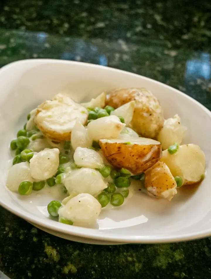 creamed new potatoes with peas and onions