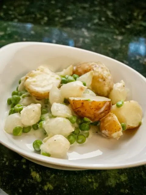 creamed new potatoes with peas and onions