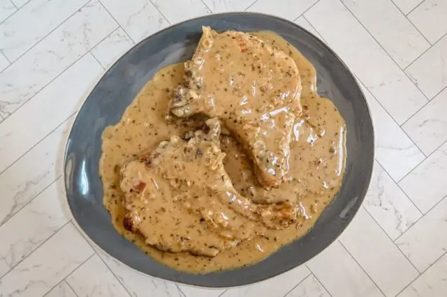 creamy pork chops with apple cider sauce on a serving platter