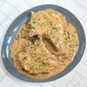 creamy apple cider pork chops with chives garnish