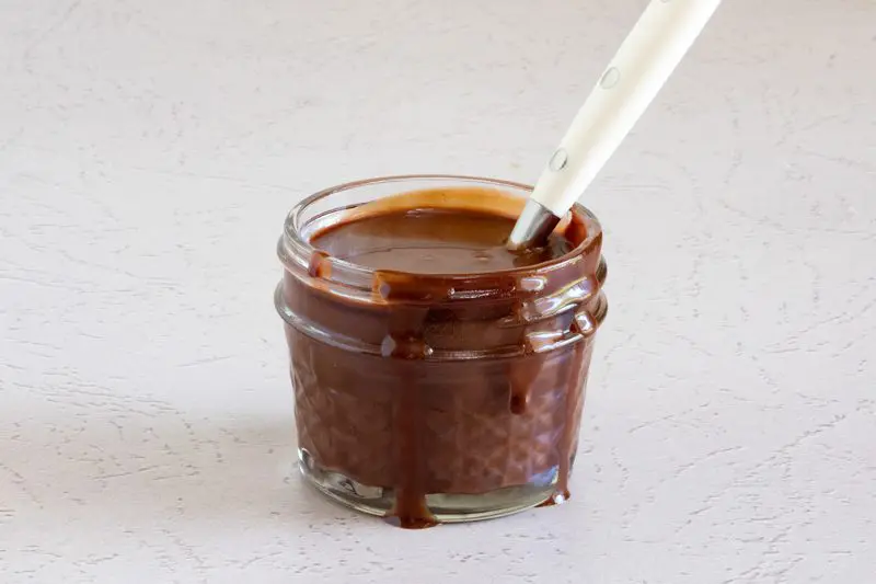 sugar free chocolate sauce in a small jar with spoon