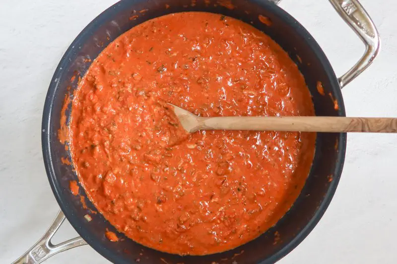 making the tomato sauce for the creamy spaghetti casserole