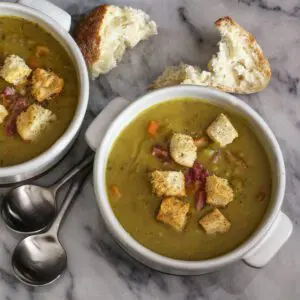 slow cooker split pea soup in bowls with croutons