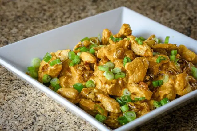 leftover turkey curry with raisins and spices in a serving bowl