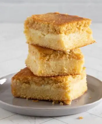 custard cornbread stacked on a plate