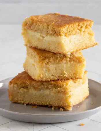 custard cornbread stacked on a plate