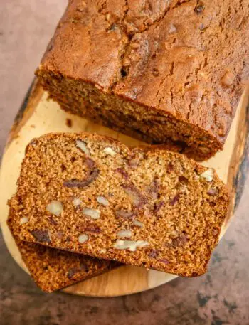 date nut bread on a wood slab, sliced