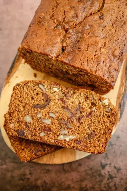 date nut bread on a wood slab, sliced