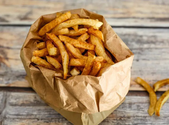 deep fried french fries in a paper bag