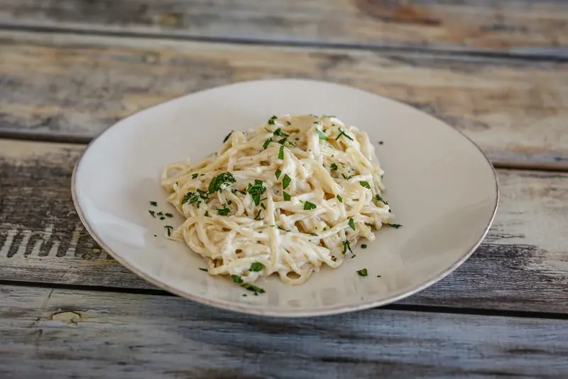 pasta with easy alfredo sauce on a plate with garnish.