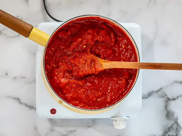 Simmering pizza sauce.