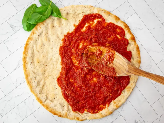 Sauce on a pizza crust.