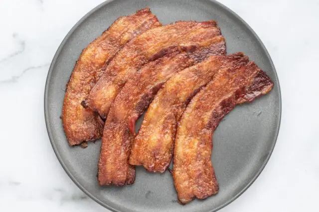 A plate of baked bacon.