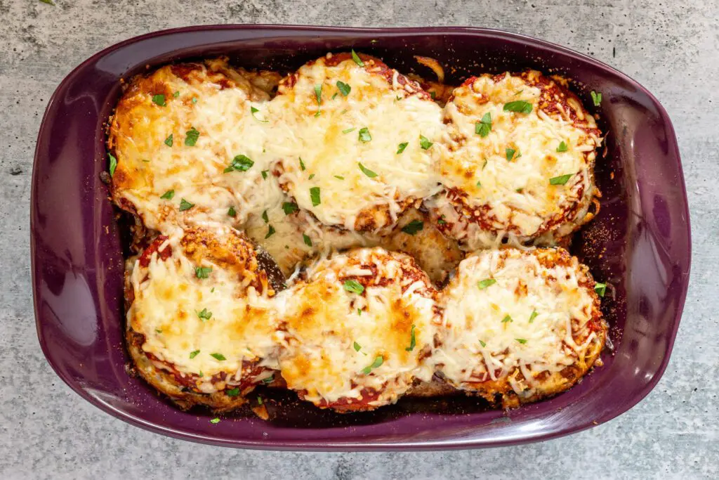 baked eggplant parmesan with parsley garnish