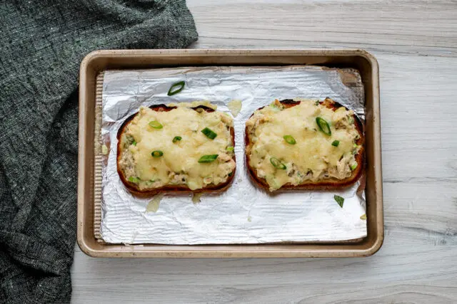 Broiled tuna melts on the baking sheet.