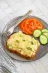 Tuna melt sandwiches, open-faced, with sliced tomatoes and cukes on the side.