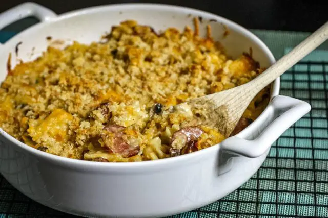 Farfalle, sausage, and cheese casserole in a baking dish.