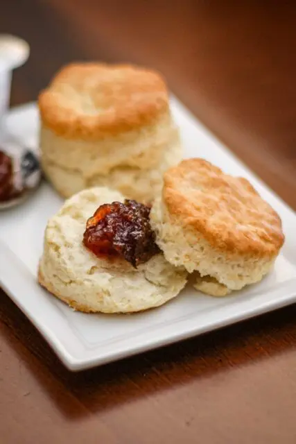 flaky buttermilk biscuits on a plate with jam