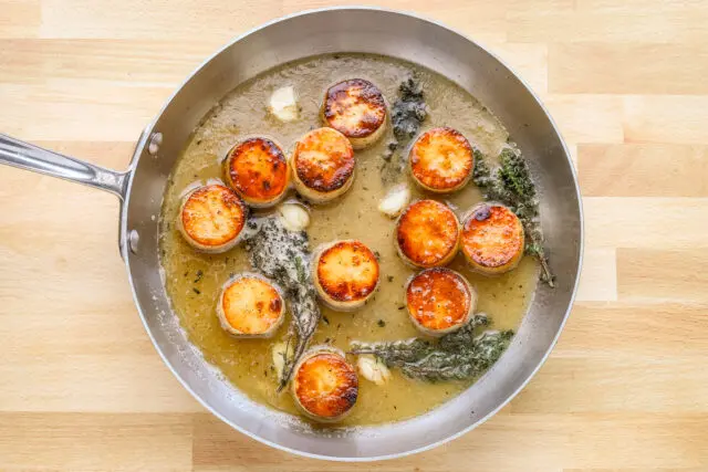 Chicken stock goes into the skillet and the potatoes are finished in the oven.