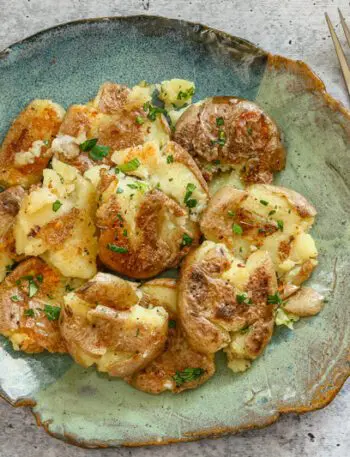 crispy fried smashed potatoes on a plate