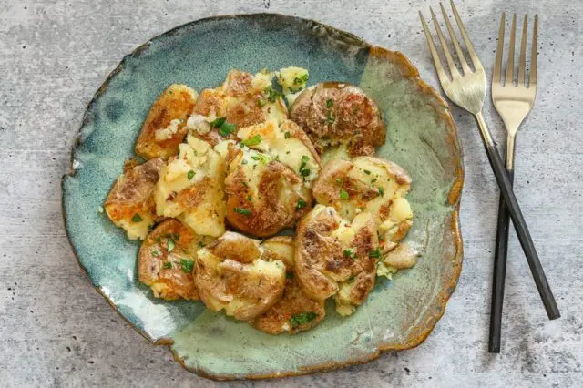 crispy fried smashed potatoes on a plate